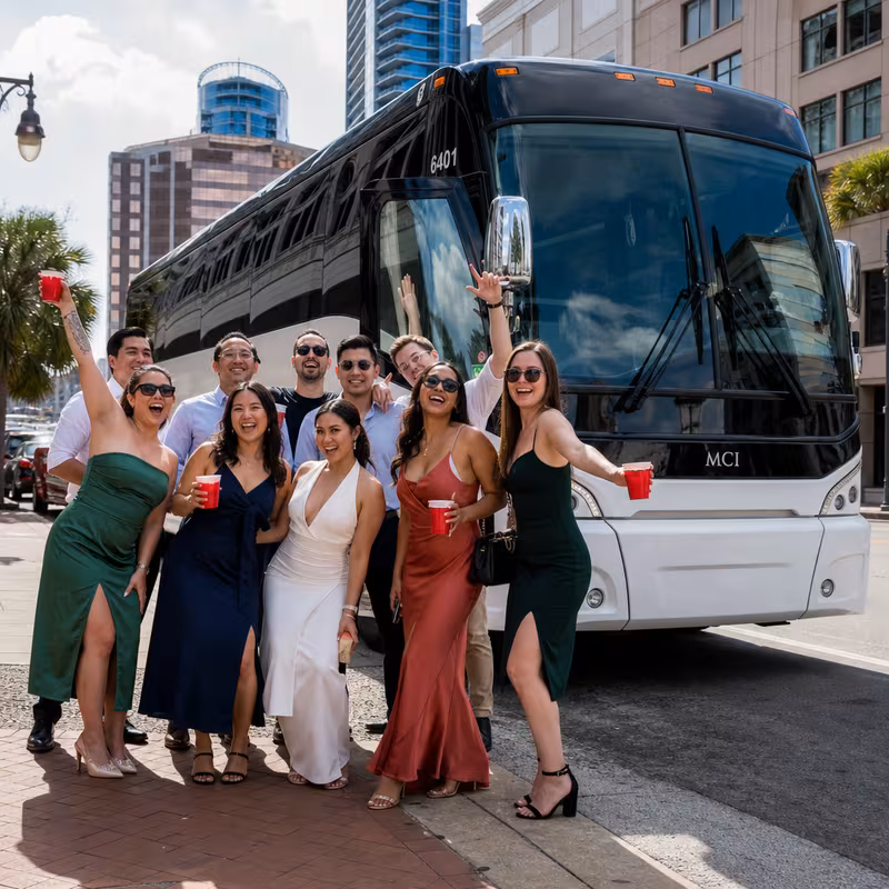 Passengers loading luggage while boarding an Orlando group shuttle