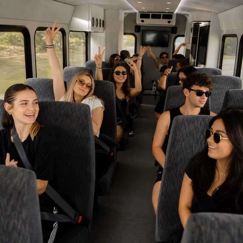 Party bus interior with wraparound leather seating and LED lighting in Orlando