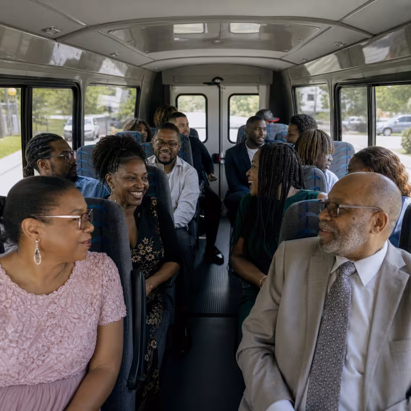 Group boarding a white charter bus for Private Event Transportation transportation in Orlando