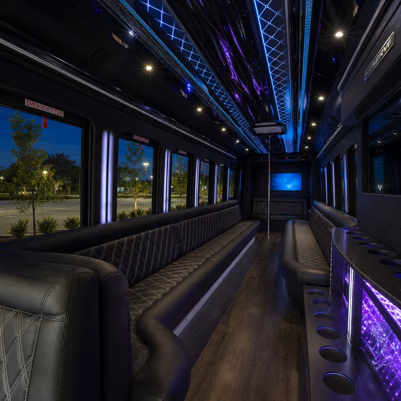 Party bus interior with wraparound leather seating and LED lighting in Orlando