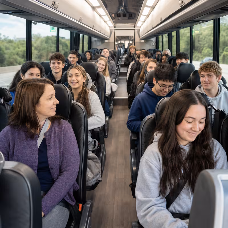 Group boarding a white charter bus for School Transportation transportation in Orlando