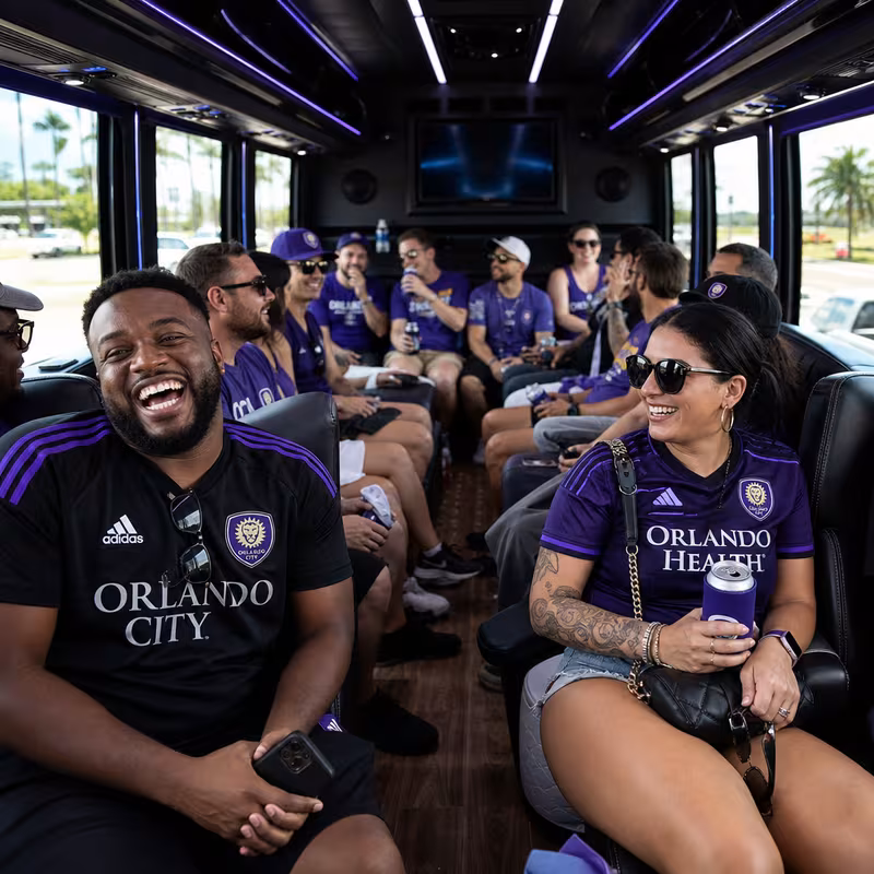 Group boarding a white charter bus for Sporting Event Transportation transportation in Orlando