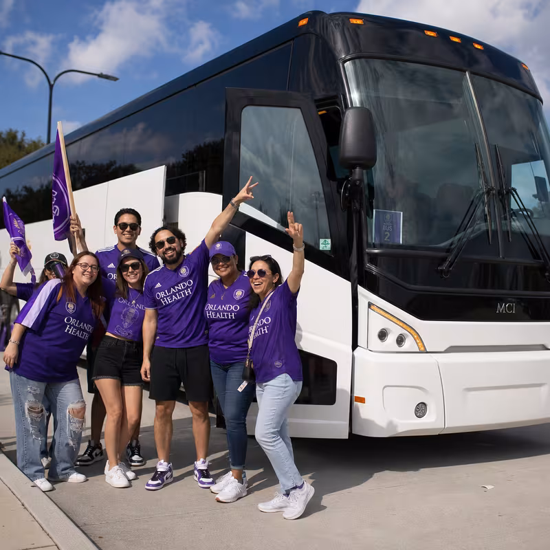 Passengers loading luggage while boarding an Orlando group shuttle