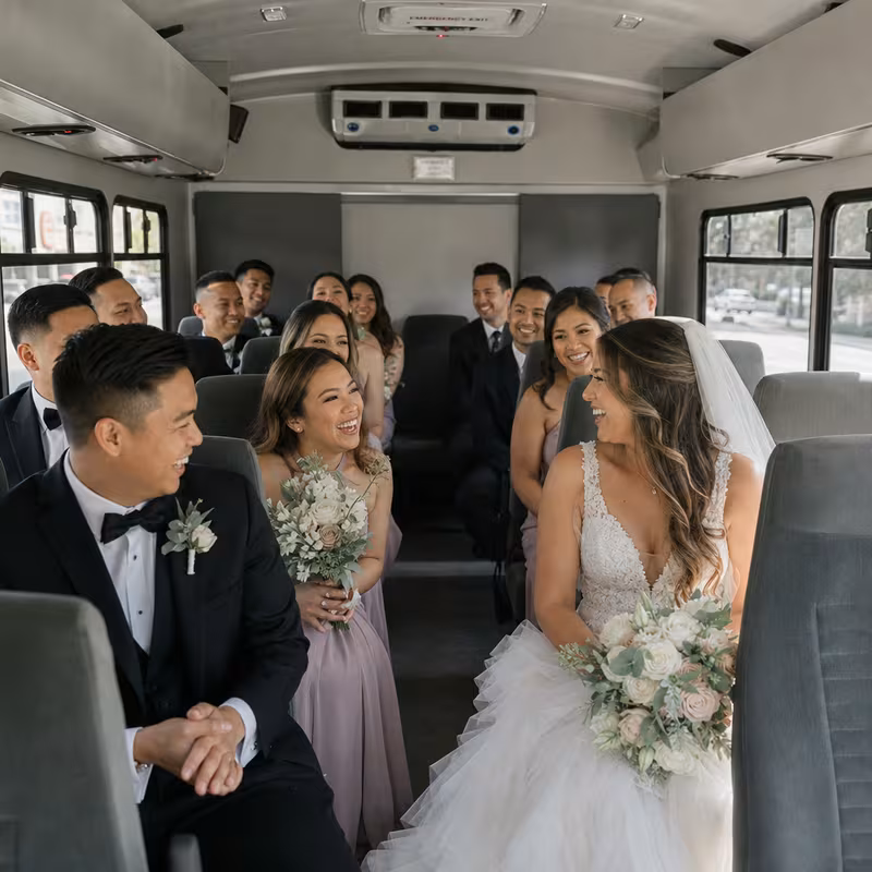 Group boarding a white charter bus for Wedding Transportation transportation in Orlando